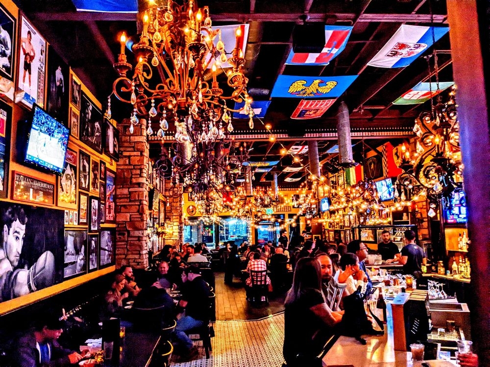 Chandeliers and flags over the packed Roman Cucina dining room